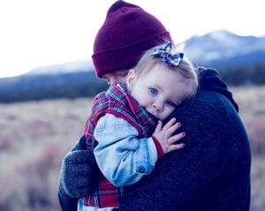 father holding his daughter in cold weather