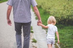 grandfather holding hands with his granddaughter