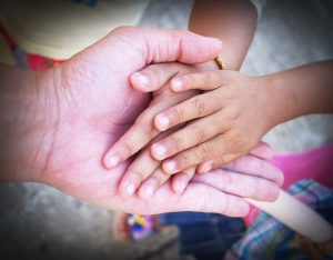 grandparent holding hands with two children